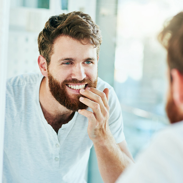 man smiling in a mirror
