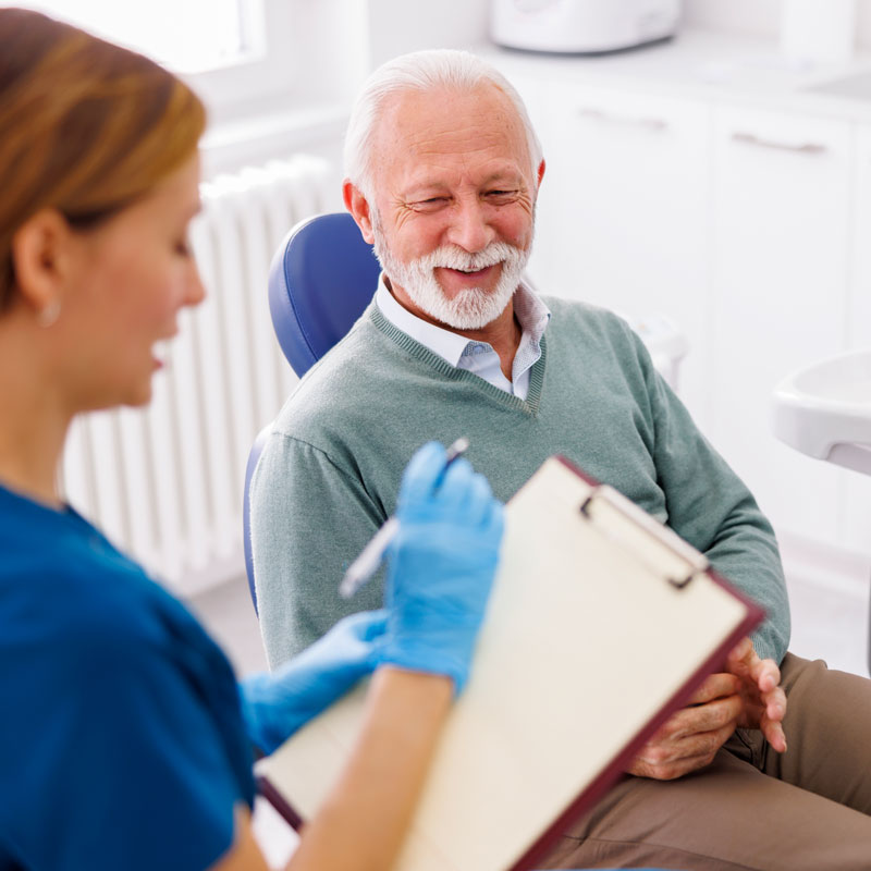 man talking with dentist